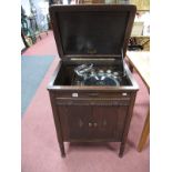 An Early XX Century Oak Cased Floor Standing Gramaphone Cabinet, knulled frieze, on lobed tapering