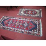 A Middle Eastern Wool Tassled Runner, with three central motifs within geometric border on red