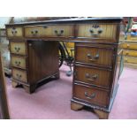 A Mahogany Pedestal Desk, with red leather sciver, two top drawers fall front drawer, pedestals with