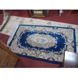 Chinese Wool Tasselled Rug, with floral oval central motif and border, 152 x 91cm; Chinese wool