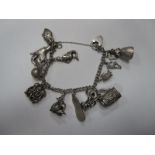 A Curb Link Charm Bracelet, to heart shape padlock clasp, suspending assorted novelty charm pendants