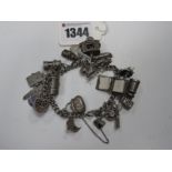 A Curb Link Charm Bracelet, suspending numerous novelty charm pendants, including miners lamp,