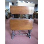 An Early XX Century Walnut Two Tier Sutherland Table, with drop leaves, on turned supports.