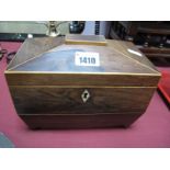 An Early XIX Century Rosewood Tea Caddy, of sarcophagus form, boxwood stringing, on ball feet.