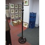 An Early XX Century Mahogany Standard Lamp, with circular base, on three bun feet.