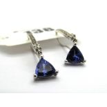 A Pair of Modern 18ct White Gold Tanzanite and Diamond Set Earrings, each trillion cut tanzanite