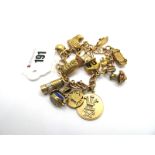 A 9ct Gold Charm Bracelet, suspending numerous novelty charm pendants, including a lantern, miner'