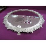 A Silver Plated Mirror Plateau, of circular form, the intricate border detailed in relief with
