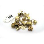 A Curb Link Charm Bracelet, suspending numerous novelty charm pendants including 9ct gold kidney