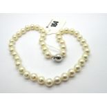 A Modern Single Strand Uniform Pearl Bead Necklace, to plain ball clasp stamped "750".