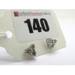 A Pair of Modern 18ct White Gold Three Stone Diamond Earstuds, each claw set with three uniform