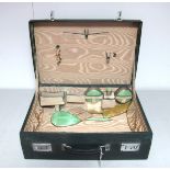 A Dark Green Leather Ladies Travelling Case, part fitted with pale green enamel backed brush, hand