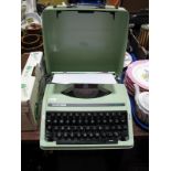 A 1970's Silver Reed SR22 Portable Typewriter, in a mint green colour, black keys.