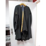 A J. Wippell & Co Ltd University Graduation Gown, Hood and Mortar Board, with orange trim.