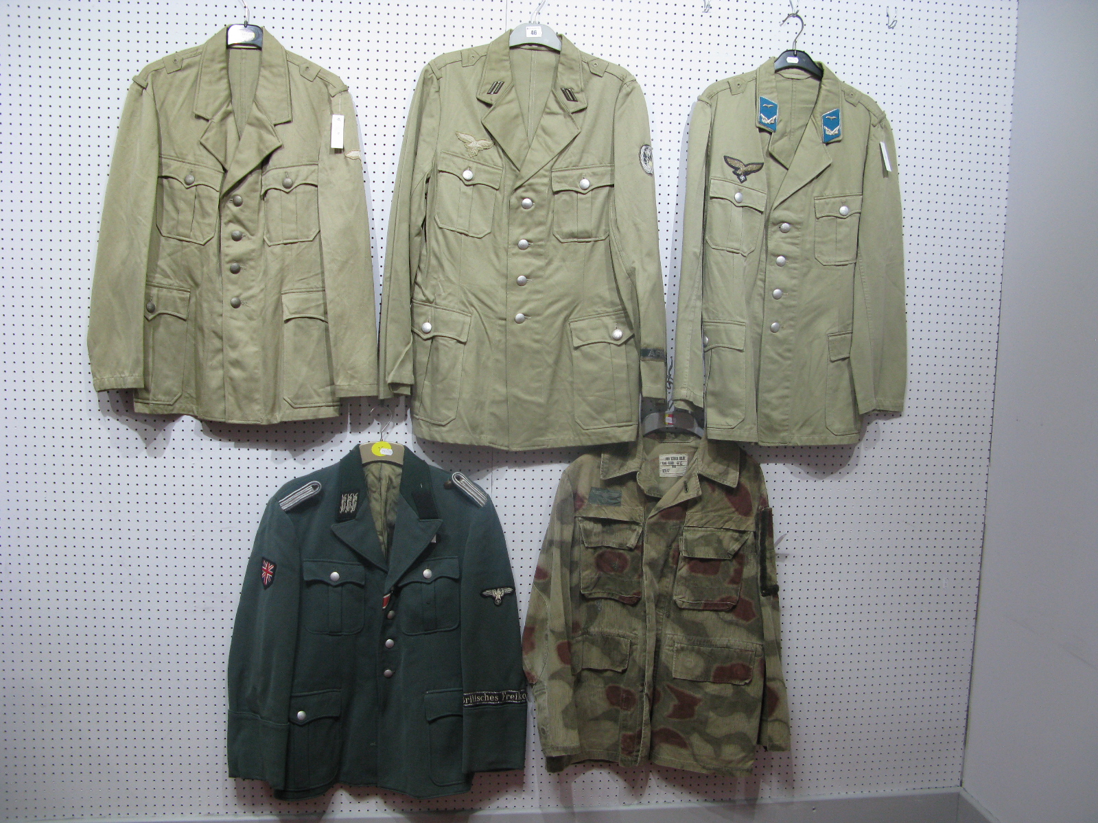 Five Post War German Military Tunics, some with copy Third Reich badges.