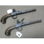 A Pair of XVIII Century Flintlock Overcoat Pistols by Griffin of London, walnut grips with wire