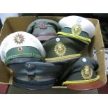 Six Second Half XX Century World Military Peaked Caps with Badges, including Argentinian Military.