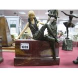 A Reproduction Art Deco Style Bronze Effect and Resin Model of a Seated Lady, on stepped veined