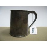 A Hallmarked Silver Mug, of tapering cylindrical form, with reeded bands, 10.2cm high.