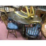 An Ercol Dining Suite, comprising six tall hoop back chairs and an extending 'D' ended table on