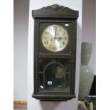 An Early XX Century Oak Cased Wall Clock, silvered dial, Arabic numerals.