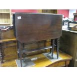 An Edwardian Mahogany Sutherland Table, with drop leaves, rail supports.