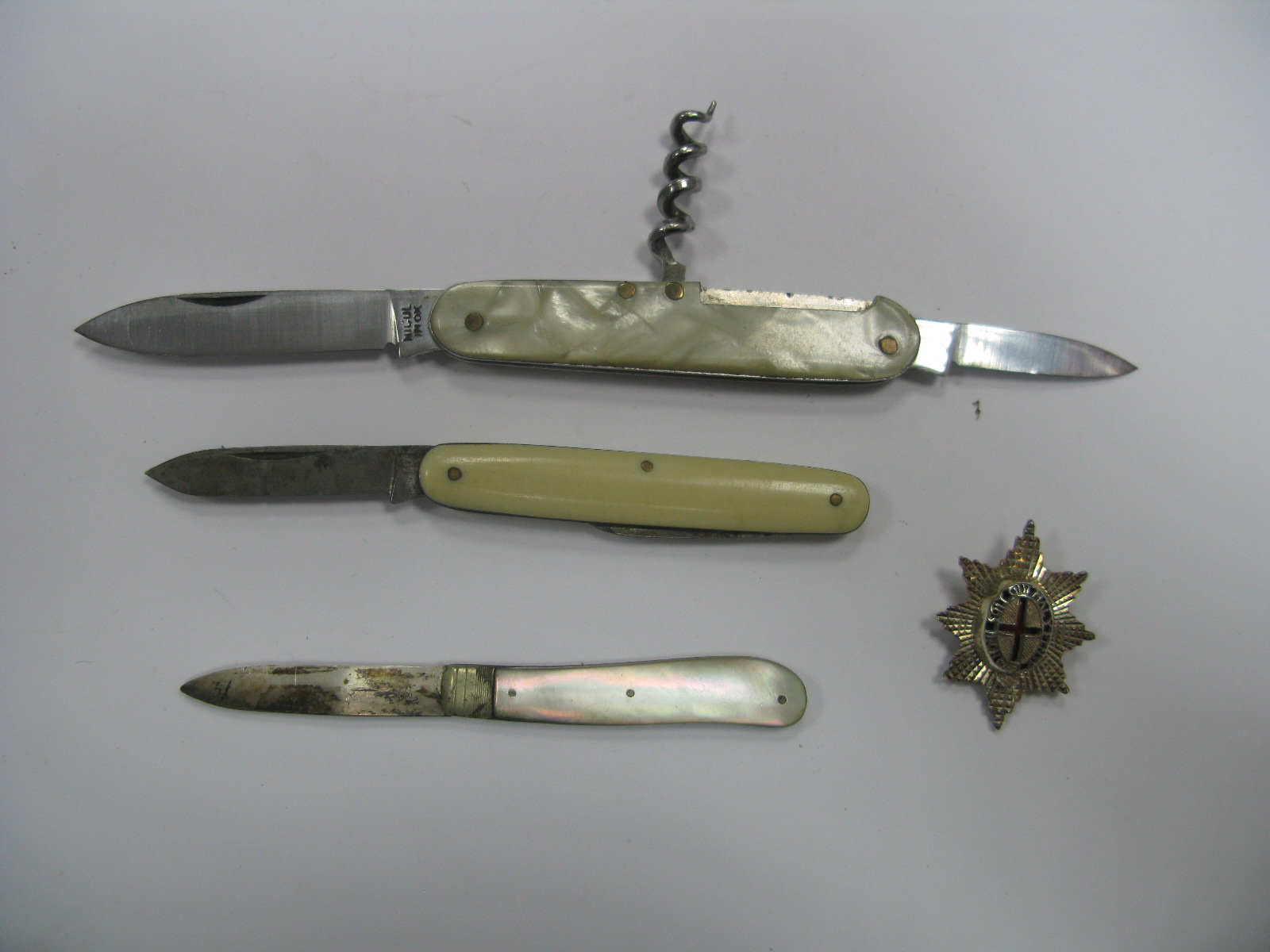 A Hallmarked Silver and Mother of Pearl Single Blade Folding Fruit Knife, two folding penknives