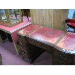 A Mahogany Desk, circa mid XX Century, with bowed flights of four drawers, flanking single drawer,