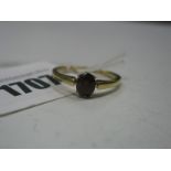 A Single Stone Dress Ring, oval claw set, stamped "18c".