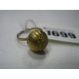 A Stylish Dress Ring, as a textured sphere, between bifricated shoulders, stamped "14K".