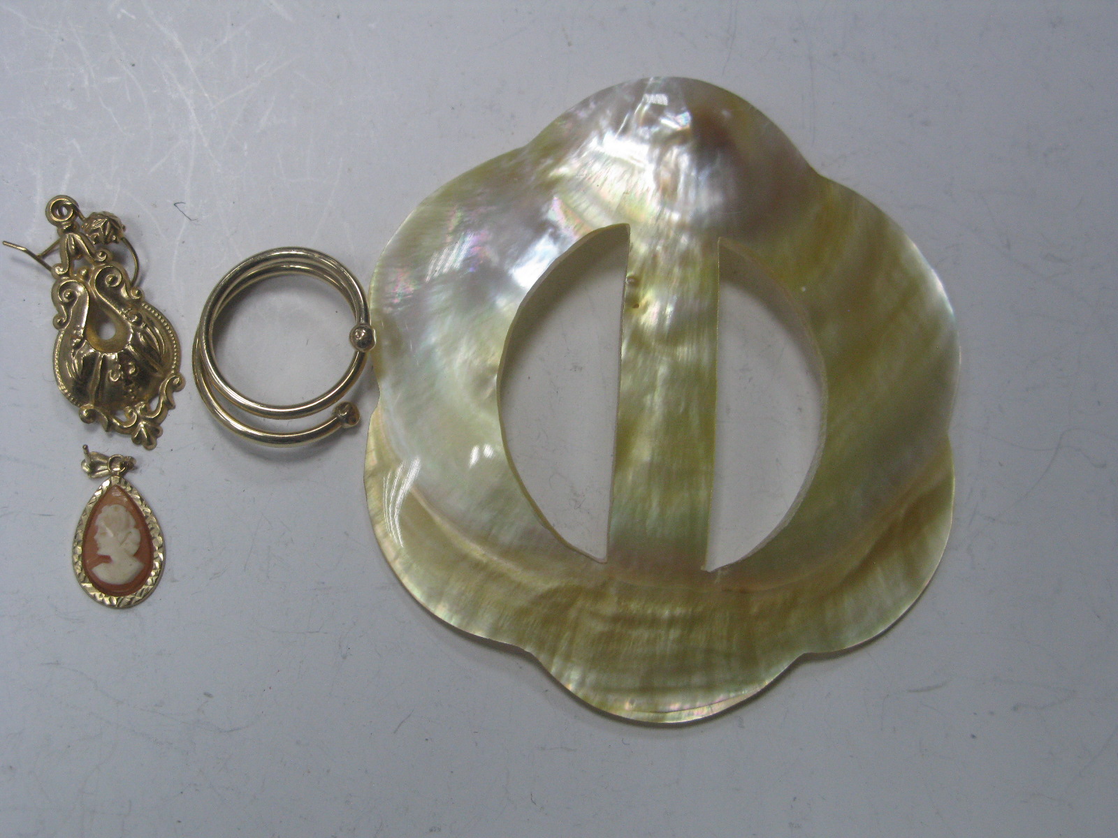 A Torque Style Dress Ring, a single fancy drop earring, and another, together with a shell carved