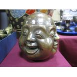 A Chinese Bronzed Paperweight, as four gent's heads, with varying expressions, 11.5cm high
