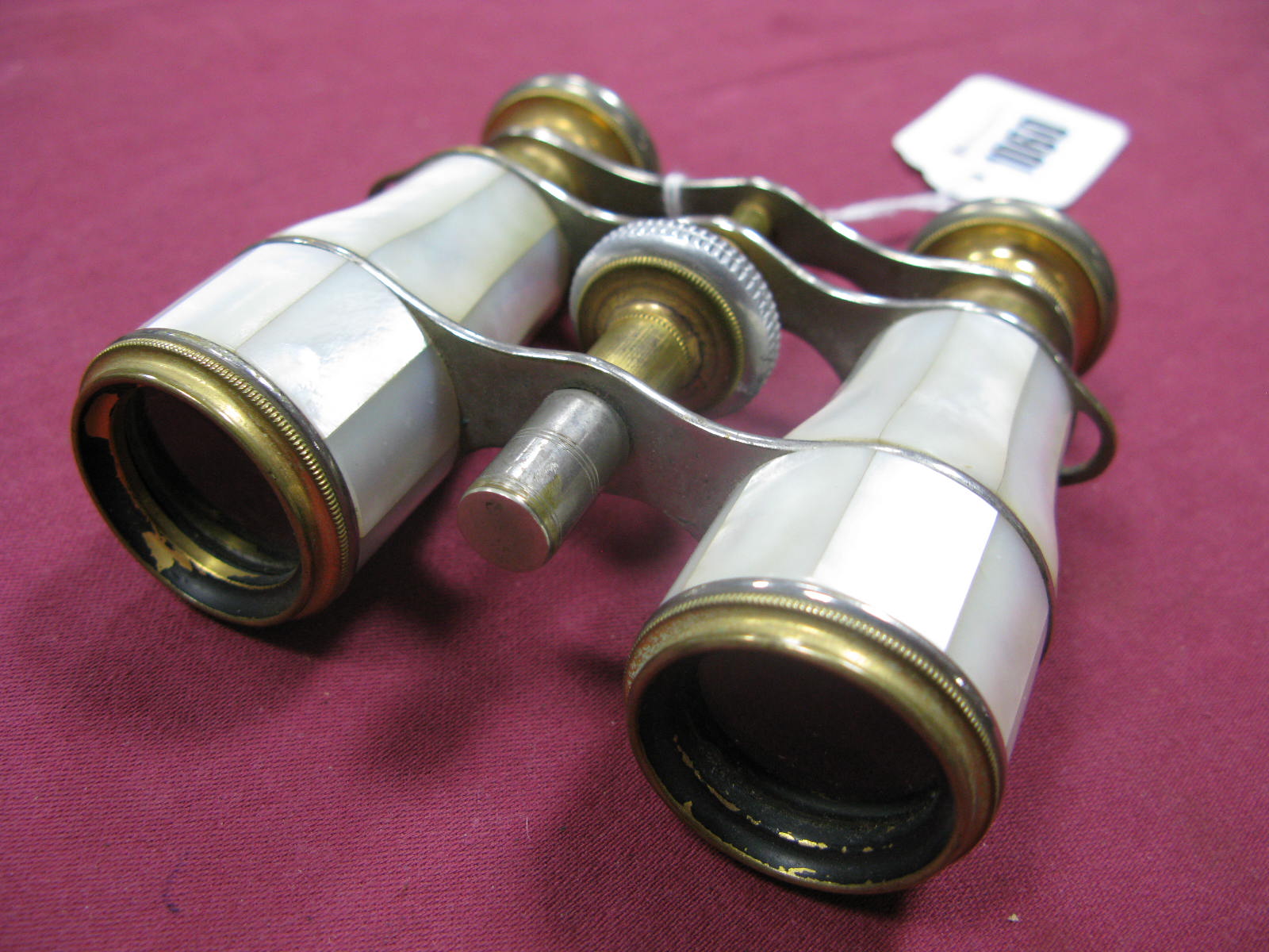 A Pair of Late XIX Century Mother of Pearl and Gilt Opera Glasses, with mother of pearl eye