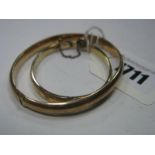 A 9ct Gold Plain Bangle, to snap clasp, together with another similar child's bangle, foliate