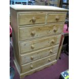 A Straight Fronted Pine Chest, of two short and four long drawers, having turned handles on plinth