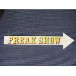 A Cut Wooden Arrow, painted with the words "Freak Show", c.120cm long.