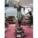 A Reproduction Bronze Effect Art Deco Style Dancing Figurine, cream resin head, on shaped triangular