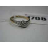 An 18ct Gold Single Stone Diamond Ring, the brilliant cut stone claw set, between textured