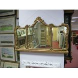 A XIX Century Style Gilded Wall Mirror, with shaped top, C scroll decoration.