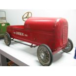 A Mid XX Century Pressed Steel 'Duke' Pedal Car by Tri-ang/Lines Brothers, finished in red,