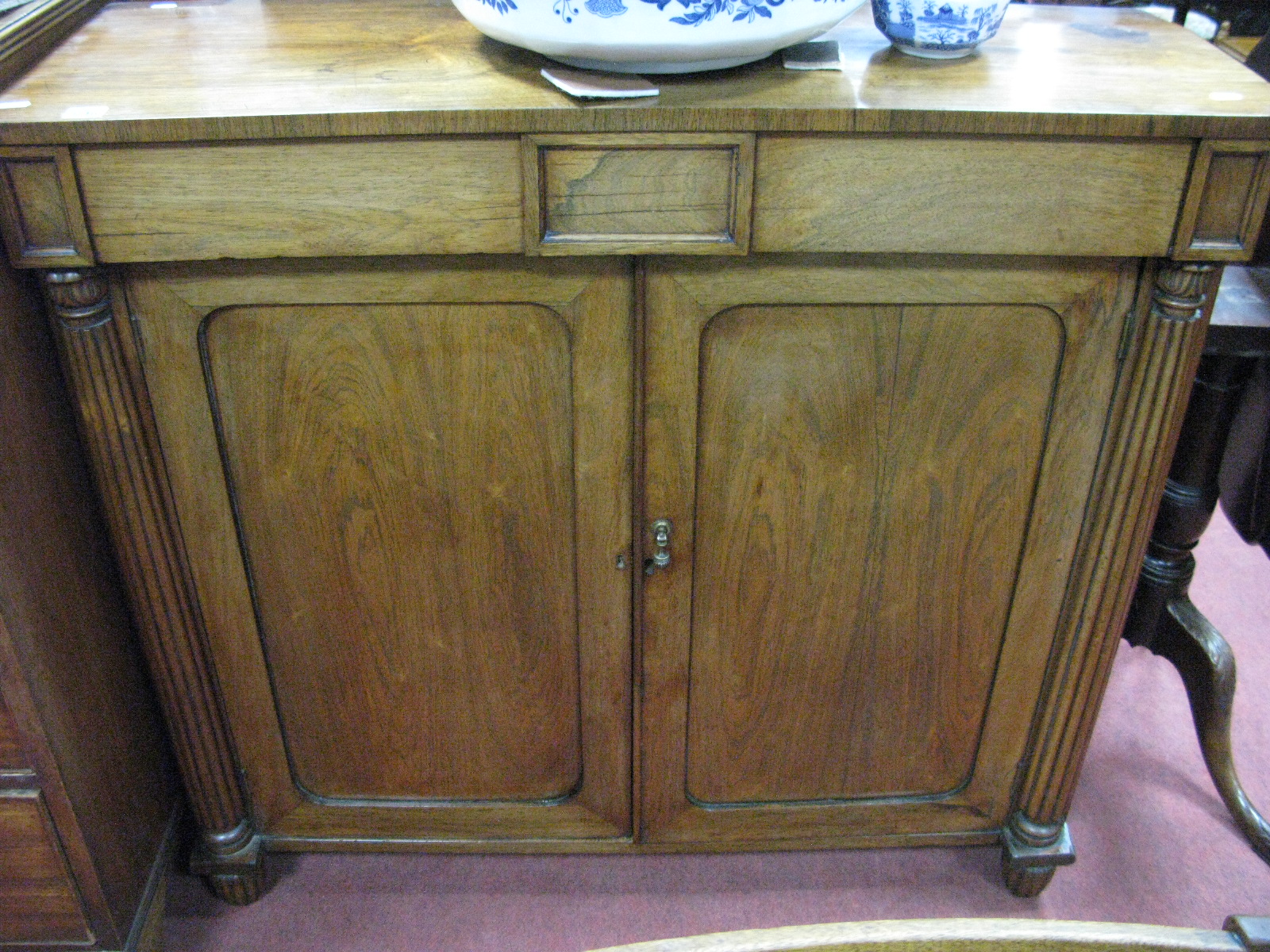 William IV Rosewood Cabinet, with twin panelled doors, reeded pillars, on reeded feet.