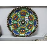 A Late XIX Century Swiss Thoune Pottery Charger, enamelled with stylistic flowers on a brown