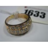 A Modern Diamond Set Three Row Gent's Ring, rubover set with graduated brilliant cut stones, stamped