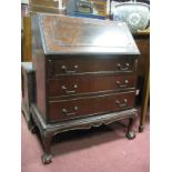 A XX Century Mahogany Bureau, with a fall front, fitted interior, three long drawers, on cabriole