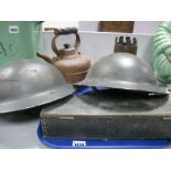 Two WWII Era British Styler Tin Hats, each with chin strap, a brass shell case vase (based