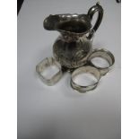 Three Hallmarked Silver Napkin Rings, varying makers and dates; a decorative cream jug, of