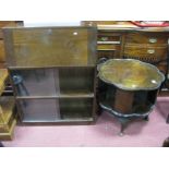 A XX Century Mahogany Revolving Bookcase, with a shaped top, open shelves on carved cabriole legs,