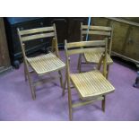 Three Mid XX Century Folding School Chairs, each with bowed backed rest and slatted seat.