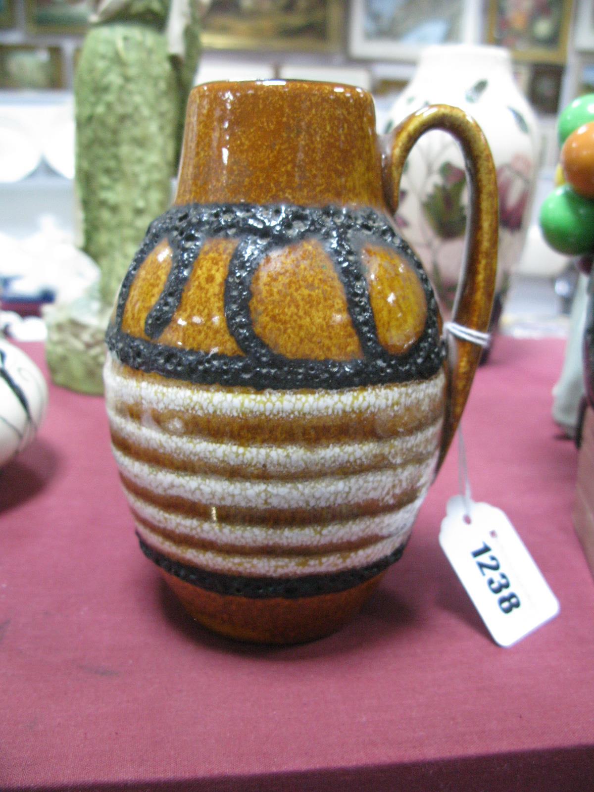 A c.1960's Small West German Fat Lava Jug Vase, the brown mottled body with lava trail and white