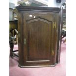 An XVIII Oak Corner Wall Cupboard, with shaped moulded door and two inner shelves.